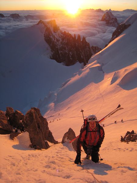 Etienne : sortie de l'epaule du Maudit sur fond de lever de soleil et de face S des Grandes Jorasses